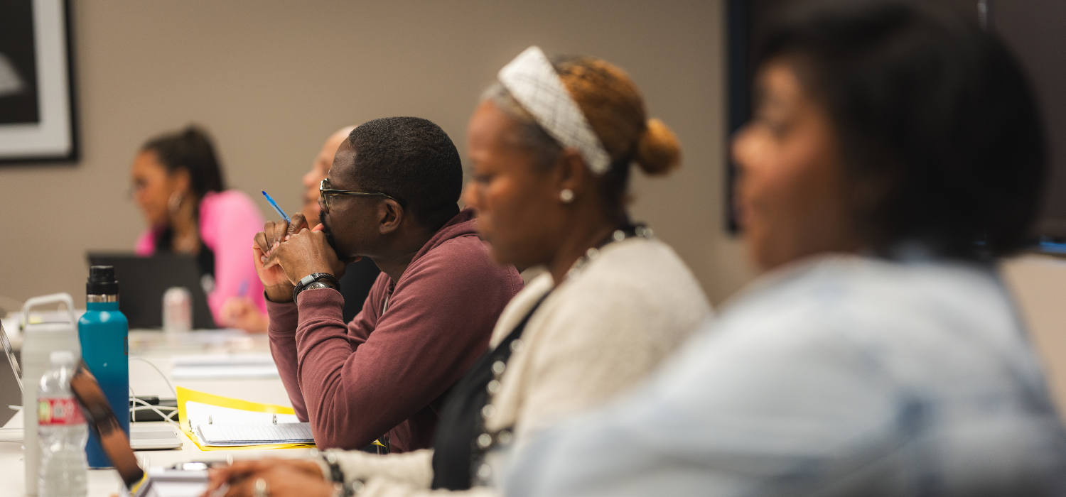 Fuller Texas cohort students listening to a lecture taking notes
